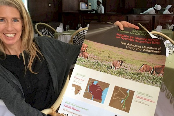 Photo of Monica Bond holding conservation poster.